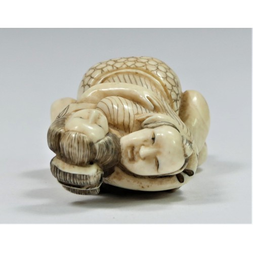 281 - A Taishō period carved ivory netsuke of a copulating couple, signed, 5cm.