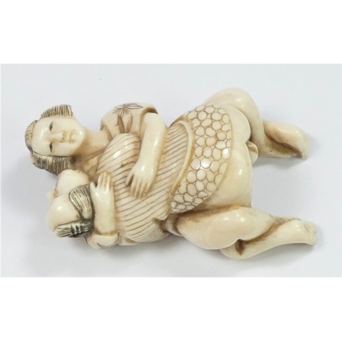 281 - A Taishō period carved ivory netsuke of a copulating couple, signed, 5cm.