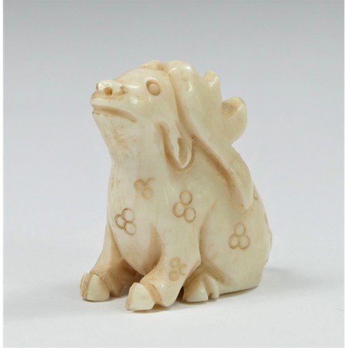 282 - A carved ivory netsuke depicting a puppy on its mothers back, 4cm, another of a rabbit with antlers,... 