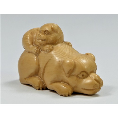 282 - A carved ivory netsuke depicting a puppy on its mothers back, 4cm, another of a rabbit with antlers,... 