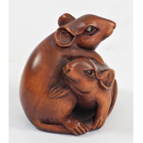 285 - A Japanese wood netsuke of two mice in a basket, signed, 4cm and three other wooden netsuke of mice,... 