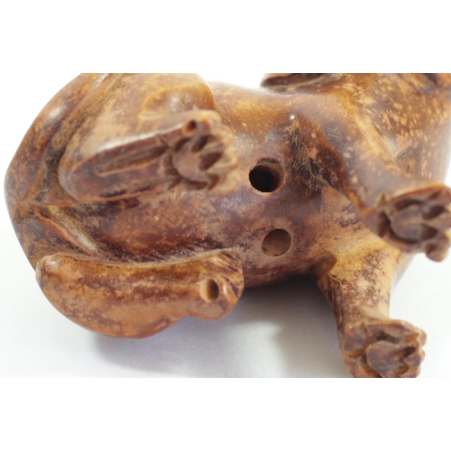 287 - A Japanese wood netsuke of a seated dog, mother of pearl disc signed, 5cm and three other wooden net... 