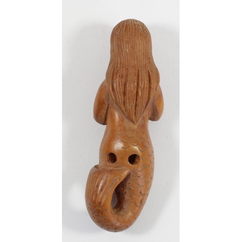 289 - A Japanese wood netsuke of a phallus with face, signed, 4.5cm, a wooden netsuke of the four faced Bu... 