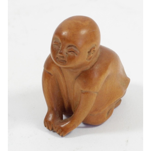 289 - A Japanese wood netsuke of a phallus with face, signed, 4.5cm, a wooden netsuke of the four faced Bu... 