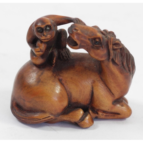 290 - A Japanese wood netsuke of a monkey on a pig, signed, 5cm, a monkey on a water buffalo, signed and t... 