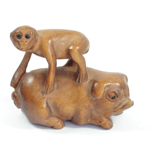 290 - A Japanese wood netsuke of a monkey on a pig, signed, 5cm, a monkey on a water buffalo, signed and t... 