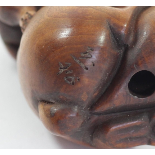 291 - A Japanese wood netsuke of a rabbit on an apple, signed, 4.5cm, two rabbits with babies on their bac... 