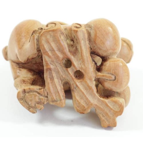 291 - A Japanese wood netsuke of a rabbit on an apple, signed, 4.5cm, two rabbits with babies on their bac... 