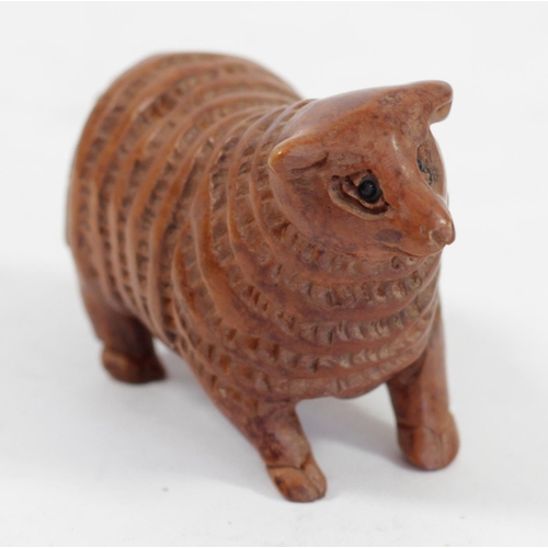 292 - A Japanese wood netsuke of a ram in a hand, signed, 5cm, together with a pig holding a basket, signe... 