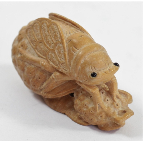 293 - A Japanese wood netsuke of a seal with her pup, signed, 6.5cm, a grass hopper on a leaf and two othe... 