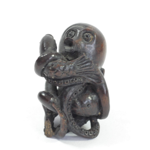 295 - A Japanese wood netsuke of an octopus fishing fish, signed, small loses, 4cm, a coiled snake, a dog ... 