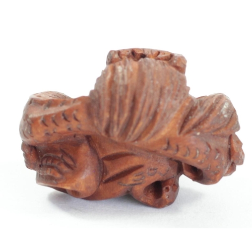 295 - A Japanese wood netsuke of an octopus fishing fish, signed, small loses, 4cm, a coiled snake, a dog ... 