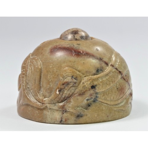 297 - A Chinese carved soapstone depicting two dragons chasing a spinning sacred pearl, 5cm