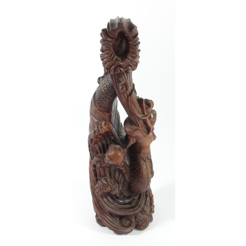 298 - A Chinese carved rootwood statue, depicting a dragon chasing the sacred pearl, 35cm