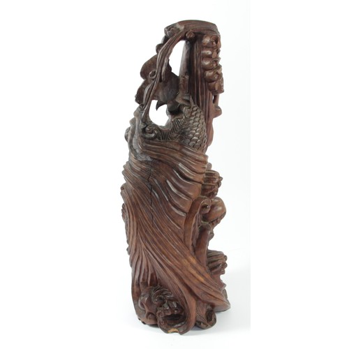 298 - A Chinese carved rootwood statue, depicting a dragon chasing the sacred pearl, 35cm