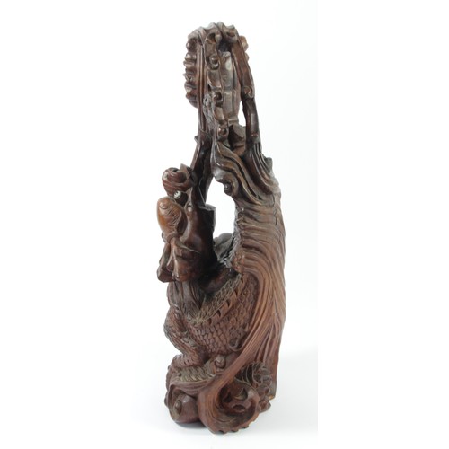 298 - A Chinese carved rootwood statue, depicting a dragon chasing the sacred pearl, 35cm