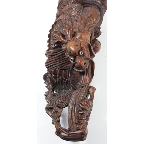 298 - A Chinese carved rootwood statue, depicting a dragon chasing the sacred pearl, 35cm