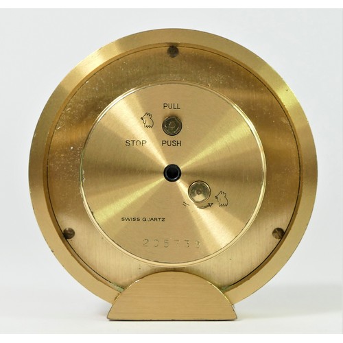 304 - Tiffany & Co. a gilt brass circular quartz alarm clock, number 205738, diameter 88mm, pouch and box.