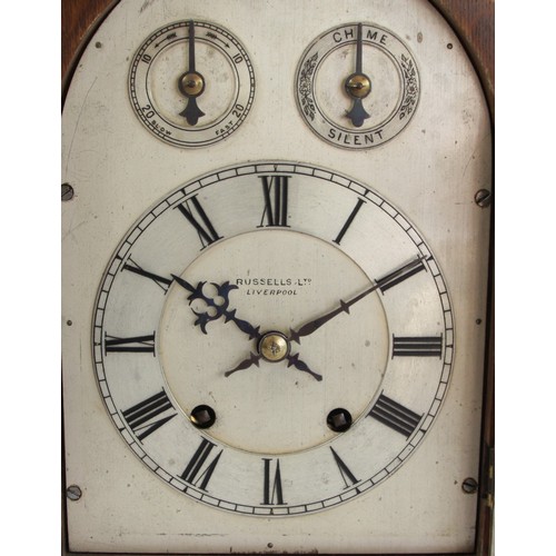 322 - Russells Ltd., Liverpool, an early 20th century oak cased mantel clock, the silvered dial with chime... 