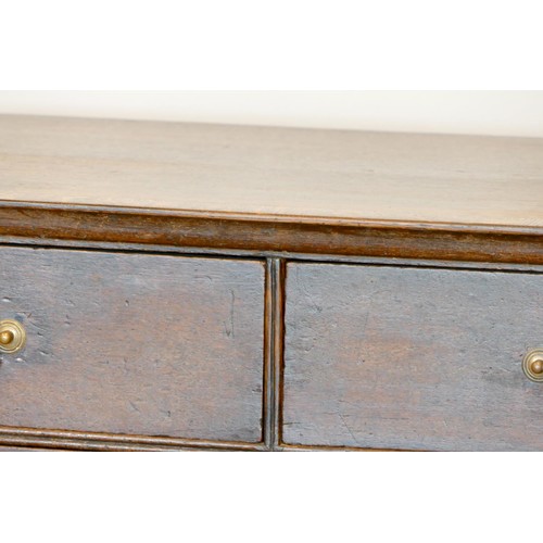 355 - A 19th century oak chest of two short over three long drawers, brass drop handles, raised on ogee br... 