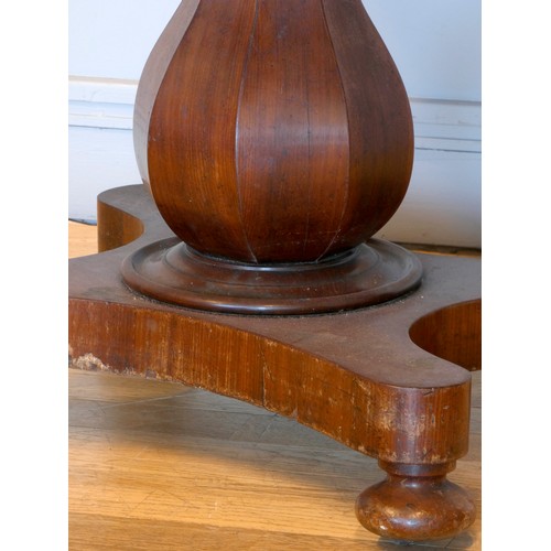 368 - A 19th century fold over side table, with swivel top, raised on an octagonal baluster stem, quatrefo... 