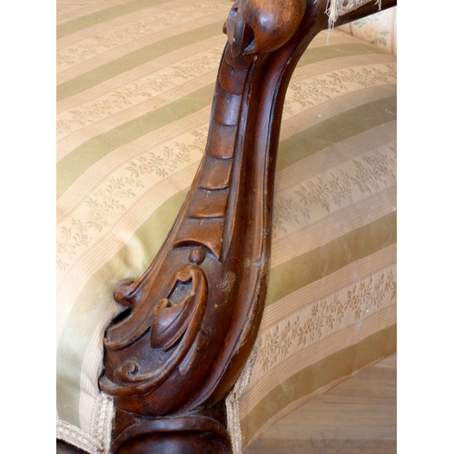 371 - A Victorian carved mahogany button back parlour chair, padded arms, with carved cabriole front suppo... 