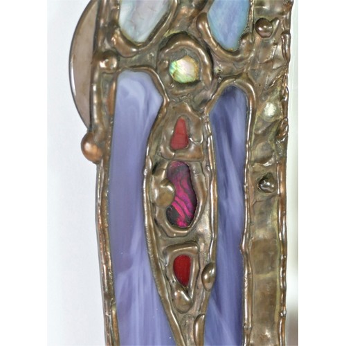 372 - John Leathwood, Hull, an arched wall mirror with night light candle holder, with multi coloured stai... 