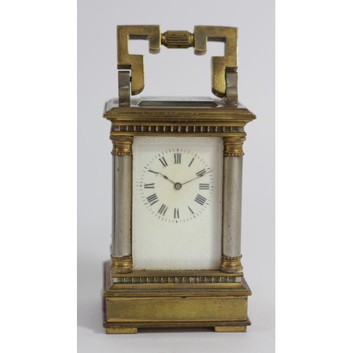 309 - A miniature brass carriage time piece, the gilt brass case with silvered columns, main spring broken... 