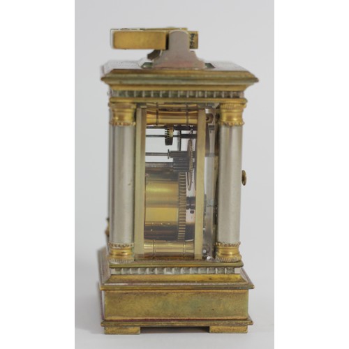 309 - A miniature brass carriage time piece, the gilt brass case with silvered columns, main spring broken... 