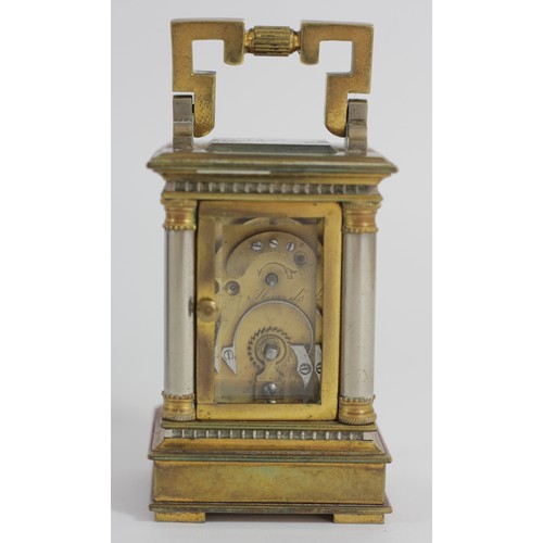 309 - A miniature brass carriage time piece, the gilt brass case with silvered columns, main spring broken... 