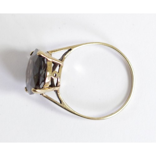 152 - A 9ct gold and smokey quartz ring, claw set with a mixed cut stone, 16 x 12mm, S 1/2, 3.2gm
