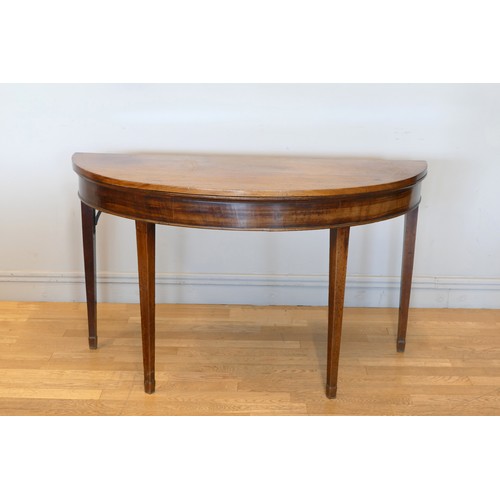 350 - A Georgian mahogany fold over demi lune side table, with two adjustable tapering legs, 127 x 110 x 7... 