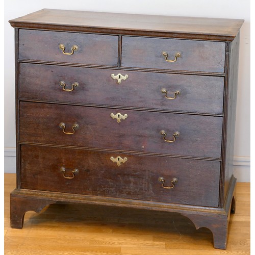 355 - A 19th century oak chest of two short over three long drawers, brass drop handles, raised on ogee br... 