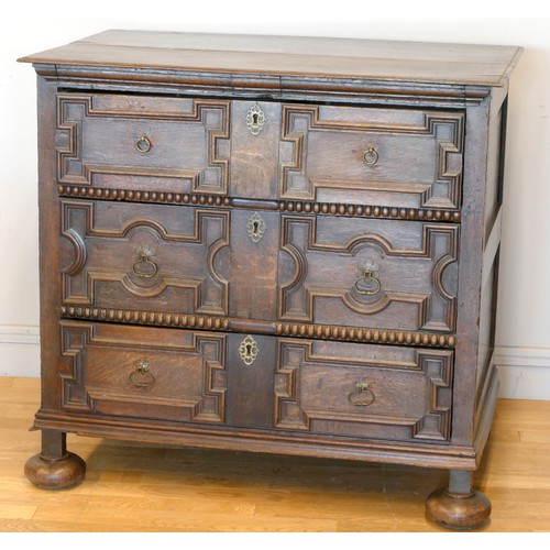 356 - A late 17th century oak chest of three long drawers, two plank top over geometric moulded drawer fro... 