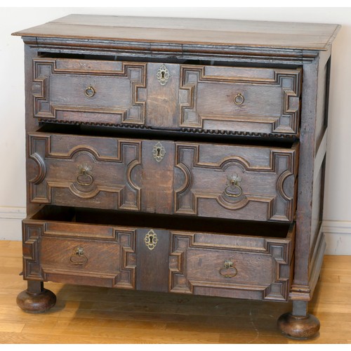 356 - A late 17th century oak chest of three long drawers, two plank top over geometric moulded drawer fro... 