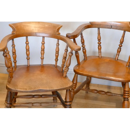 362 - A near pair of Victorian ash and elm captains chairs, scroll arms and turned supports, one stamped A... 