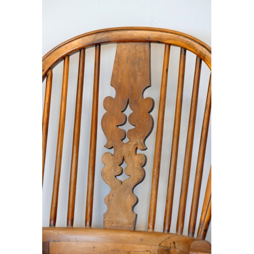 364 - A Victorian ash and elm Windsor high back arm chair, with scroll splat and turned supports, 113cm.