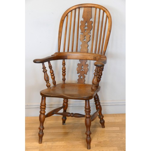 364 - A Victorian ash and elm Windsor high back arm chair, with scroll splat and turned supports, 113cm.