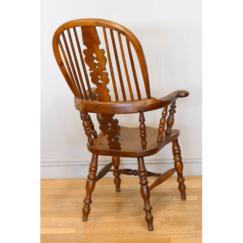 364 - A Victorian ash and elm Windsor high back arm chair, with scroll splat and turned supports, 113cm.