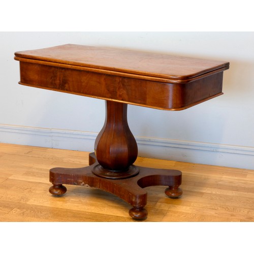 368 - A 19th century fold over side table, with swivel top, raised on an octagonal baluster stem, quatrefo... 