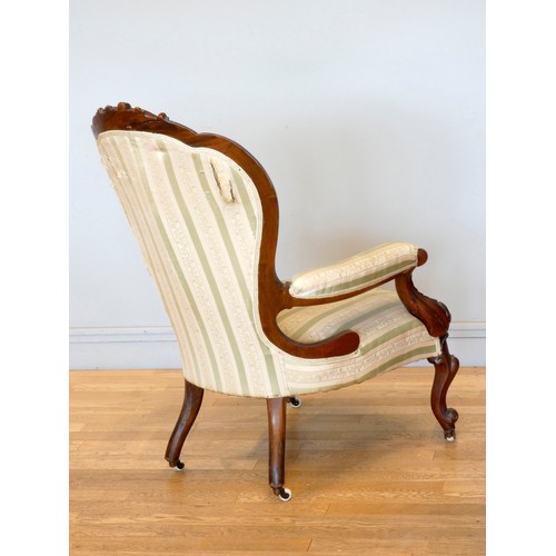 371 - A Victorian carved mahogany button back parlour chair, padded arms, with carved cabriole front suppo... 