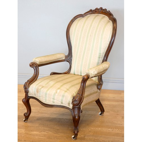 371 - A Victorian carved mahogany button back parlour chair, padded arms, with carved cabriole front suppo... 