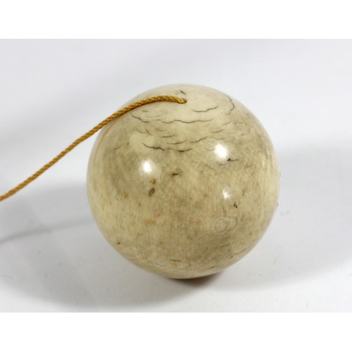 278A - A 19th Century ivory bilboquet cup and ball game, diameter 45mm