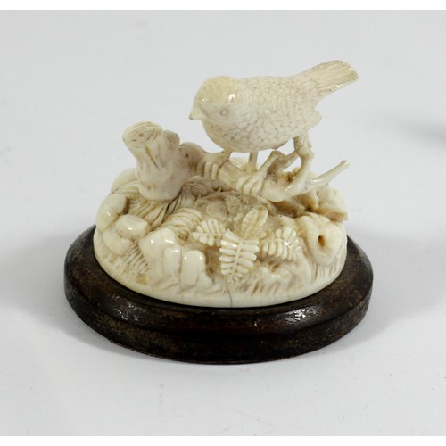 279A - A Chinese 19th century carved ivory model of a wren in foliage, A/F, 7 x 6cm, a carved ivory tape me... 