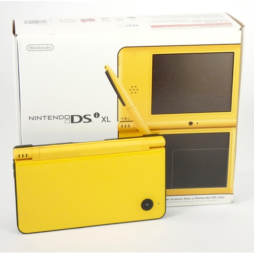 73 - A Nintendo DSi XL, original box, charger, stylus, guides and manuals (missing large stylus), togethe... 