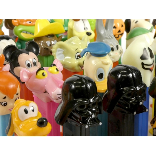 183 - A collection of fifty-four Pez dispensers, from the UK and USA, including franchise such as Garfield... 