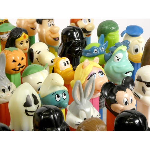 183 - A collection of fifty-four Pez dispensers, from the UK and USA, including franchise such as Garfield... 