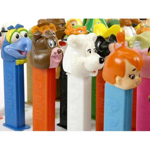 183 - A collection of fifty-four Pez dispensers, from the UK and USA, including franchise such as Garfield... 