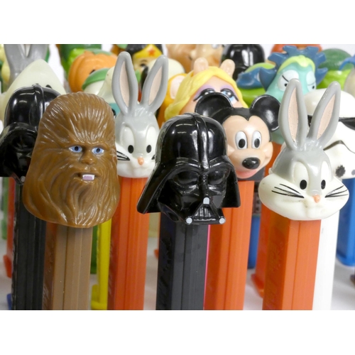 183 - A collection of fifty-four Pez dispensers, from the UK and USA, including franchise such as Garfield... 