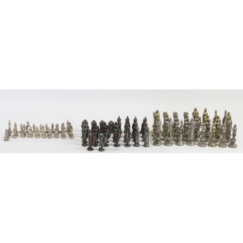 229 - A collection of three sets of cast chess pieces, one complete set, in silver, gold and bronze gilt